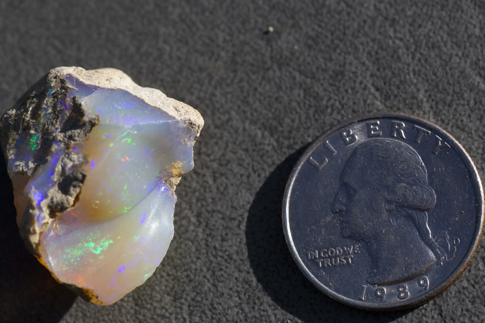 Rough Ethiopian crystal opal — before any grinding begins, the stone is attached to a dop stick to control its angle against the wheel.